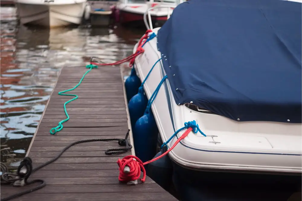 modern motor boat windshield and bow deck covered in a blue canvas